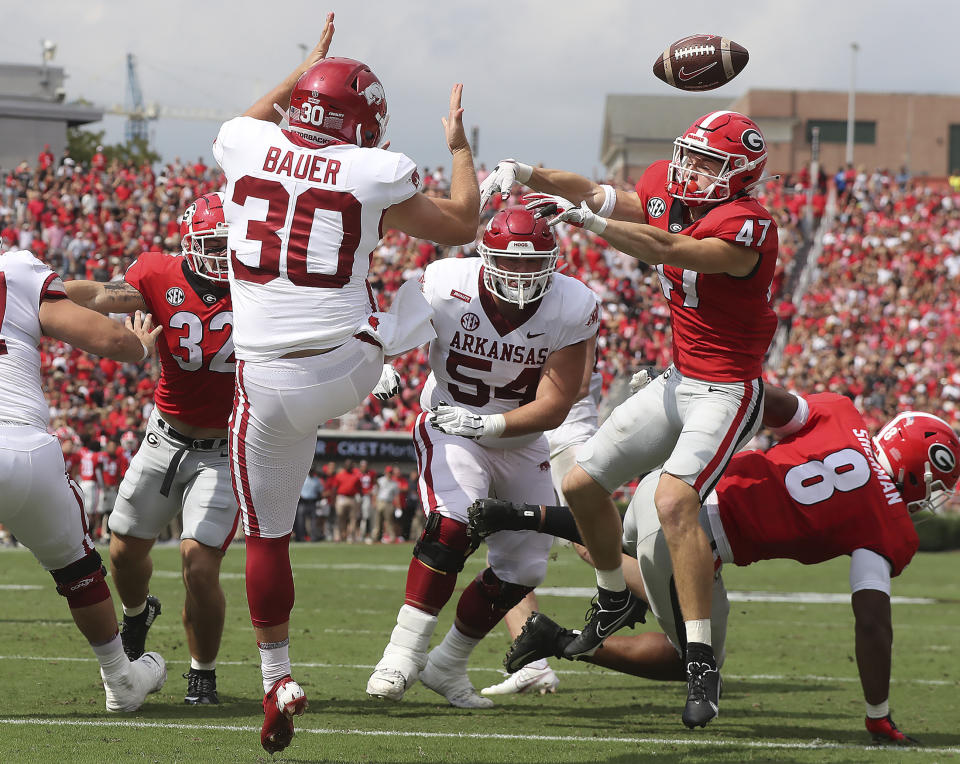 Georgia defensive back Dan Jackson blocks the punt in the end zone by Arkansas kicker Reid Bauer and Georgia recovered for the touchdown during the first quarter of an NCAA college football game on Saturday, Oct. 2, 2021, in Athens. (Curtis Compton/Atlanta Journal-Constitution via AP)