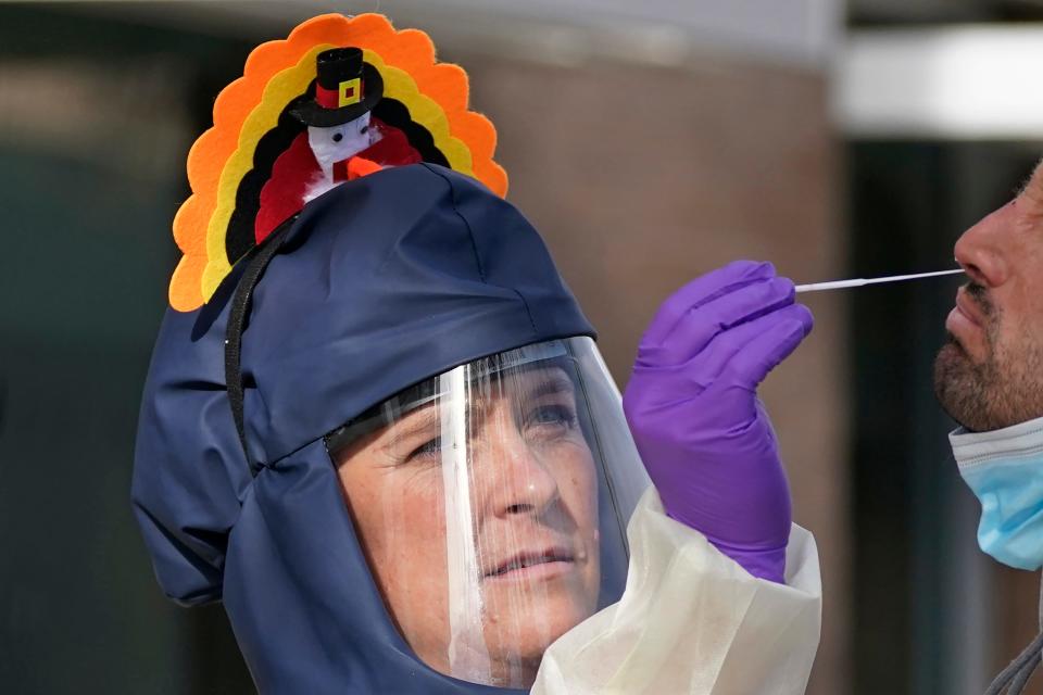 Public health nurse Lee Cherie Booth administers a coronavirus test outside the Salt Lake County Health Department on Wednesday.
