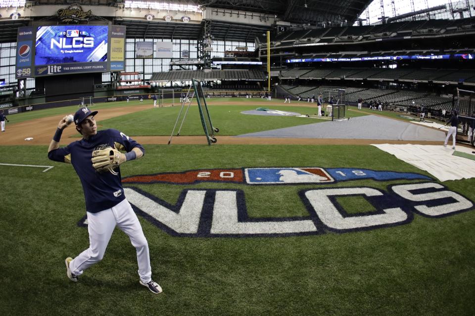 Milwaukee Brewers' Christian Yelich warms up for practice for Game 1 of the National League Championship Series baseball game Los Angeles Dodgers Thursday, Oct. 11, 2018, in Milwaukee. (AP Photo/Matt Slocum)