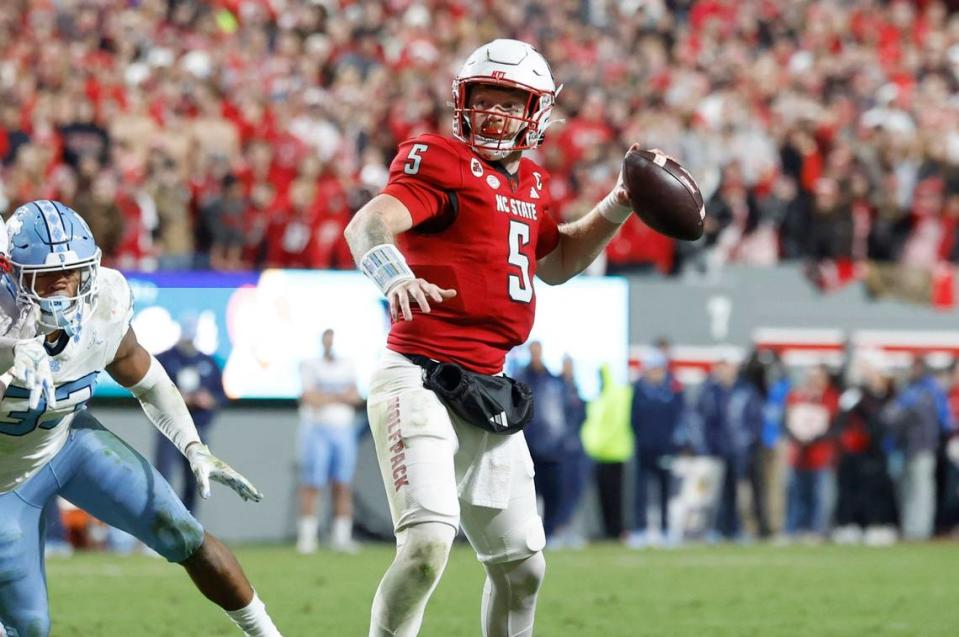 N.C. State quarterback Brennan Armstrong (5) looks to pass downfield during the first half of N.C. State’s game against UNC at Carter-Finley Stadium in Raleigh, N.C., Saturday, Nov. 25, 2023.