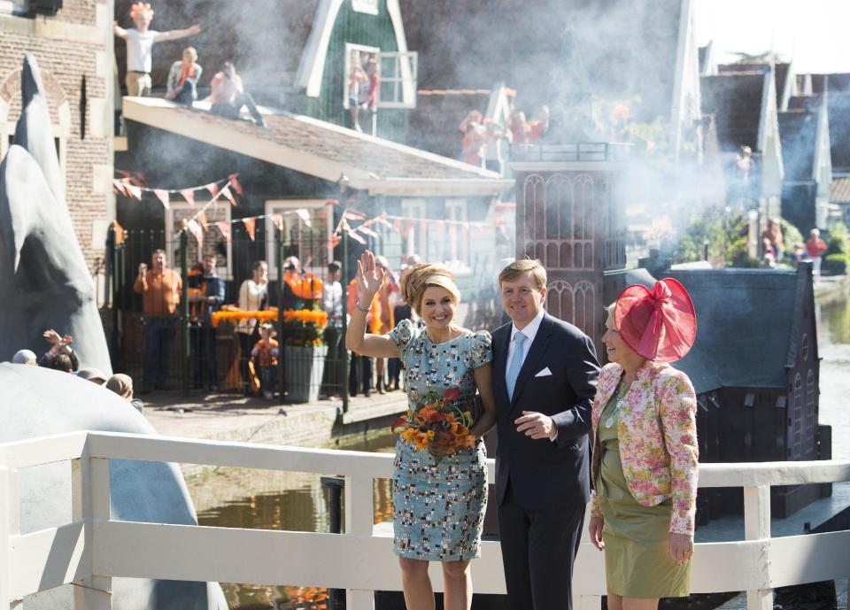 Netherlands' King Willem Alexander, center, and Queen Maxima, left, wave to well wishers at the end of festivities marking King's Day in De Rijp, 36 kilometers (22 miles) north of Amsterdam, Netherlands, Saturday, April 26, 2014. The Dutch marked King's Day on Saturday, a national holiday held in honor of the newly installed monarch, King Willem Alexander. King's Day replaces the traditional Queen's Day. (AP Photo/Patrick Post)