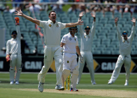 Cricket - Australia v South Africa - Third Test cricket match - Adelaide Oval, Adelaide, Australia - 24/11/16. Australia bowler Josh Hazlewood (L) appeals unsuccessfully for the wicket of South Africa's Dean Elgar (C) during the first day of the Third Test cricket match in Adelaide. REUTERS/Jason Reed