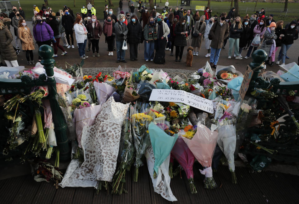 FILE - People leave floral tributes, at the band stand in Clapham Common, after a vigil for Sarah Everard was officially cancelled, in London, Saturday, March 13, 2021. British authorities have quashed plans to prosecute protesters who attended a vigil for a murdered woman during the country's pandemic lockdown. The Crown Prosecution Service said Sunday, Aug. 14, 2022 that cases against six people over the March 2021 vigil in memory of Sarah Everard had been dropped because “our legal test for a prosecution was not met.” (AP Photo/Frank Augstein, File)