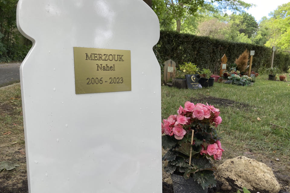 Flowers lay at the tomb of Nahel Merzouk Wednesday, July 5, 2023 in a cemetery in Nanterre, a Paris suburb. Video of the June 27, 2023 killing showed two police officers at the window of the car driven by Nahel, one with his gun pointed at the driver. As the teenager pulled forward, the officer fired once through the windshield. Nahel's death caused five nights of unrest in France. (AP Photo/Cara Anna)