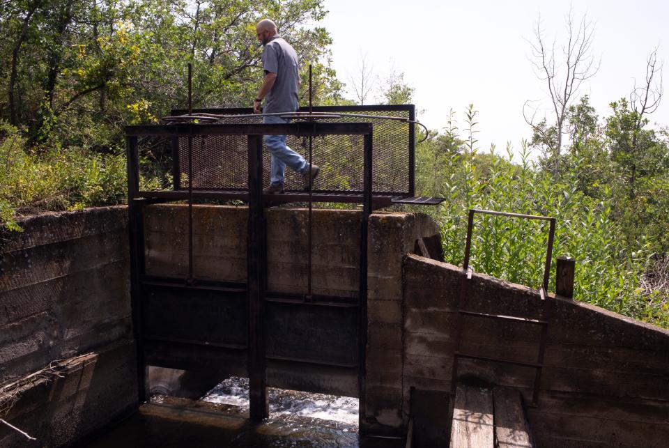 Water Commissioner James Holiman at the Big Ditch headgate north of Cedaredge, Colorado. The ditch intercepts the streams that flow down Grand Mesa and moves the water laterally toward other uses.