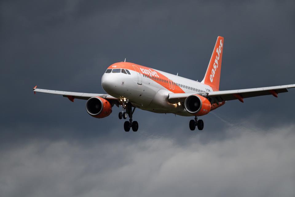 An easyJet Airbus A320 commercial plane is seen landing at Geneva Airport. Photo: Fabrice Coffrini/AFP/Getty Images