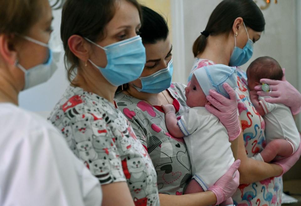 Nurses with babies born to Ukrainian surrogate mothers in Kyiv. <a href="https://www.gettyimages.com/detail/news-photo/nurses-hold-babies-as-foreign-couples-gather-to-collect-news-photo/1219071333?adppopup=true" rel="nofollow noopener" target="_blank" data-ylk="slk:Sergei Supinsky/AFP via Getty Images;elm:context_link;itc:0;sec:content-canvas" class="link ">Sergei Supinsky/AFP via Getty Images</a>