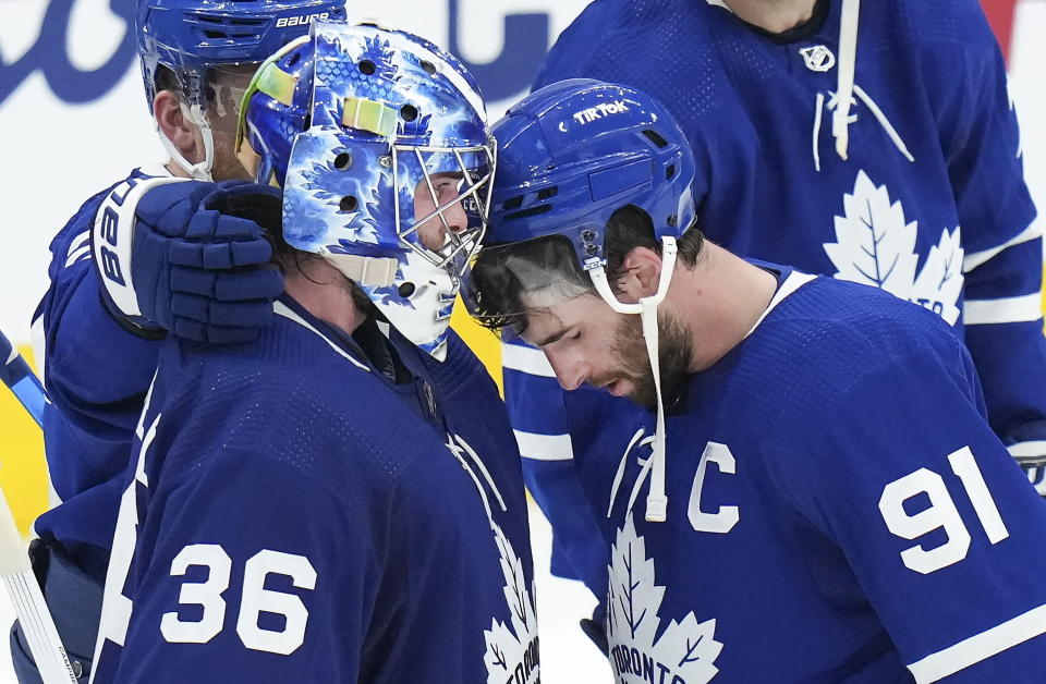 Toronto Maple Leafs forward John Tavares (91) reacts with goaltender Jack Campbell (36) after being knocked out of the Stanley Cup playoffs in Game 7 of an NHL hockey first-round playoff series against the Tampa Bay Lightning in Toronto, Saturday, May 14, 2022. (Nathan Denette/The Canadian Press via AP)