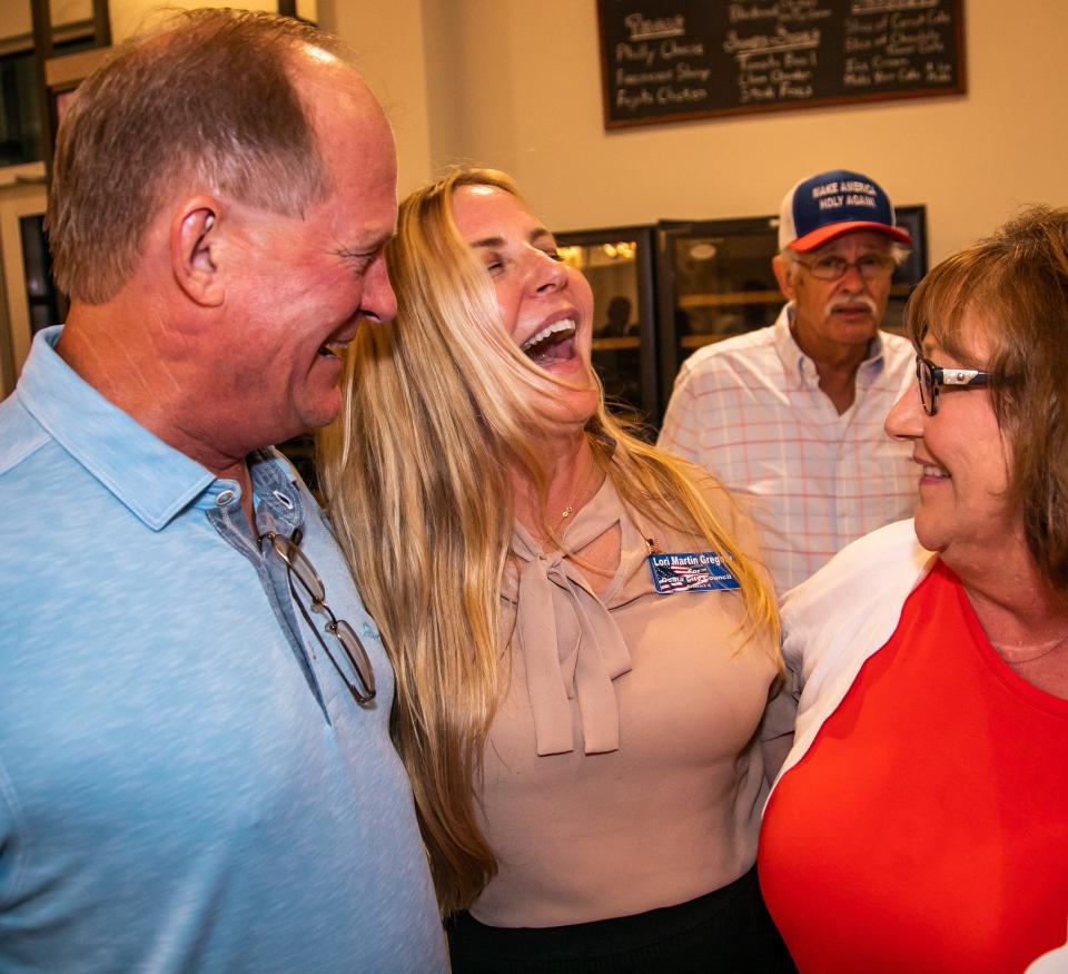 Tax Collector George Albright, left, congratulates his cousin Lori Martin Gregory, center, at an election event on Sept. 21. His annual car show helps bring in thousands of dollars for local charities.