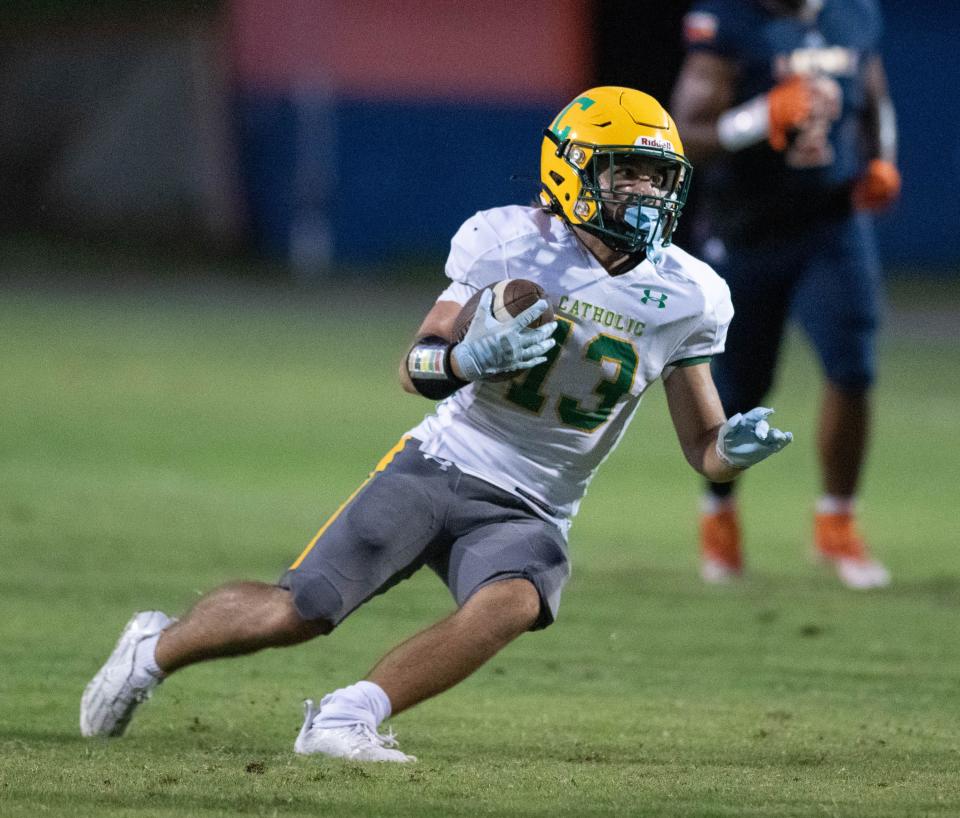 Cayden Jasso (13) carries the ball during the Pensacola Catholic vs Escambia football game at Escambia High School in Pensacola on Friday, Sept. 1, 2023.