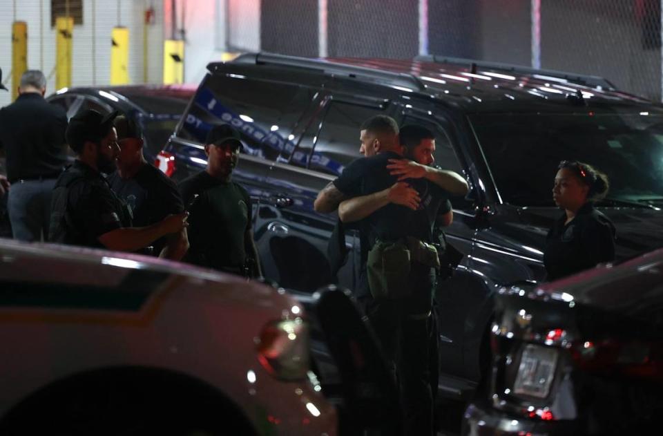 Police officers and other officials stand outside the Ryder Trauma Center after a Miami-Dade police officer what shot on Monday, August 15, 2022.