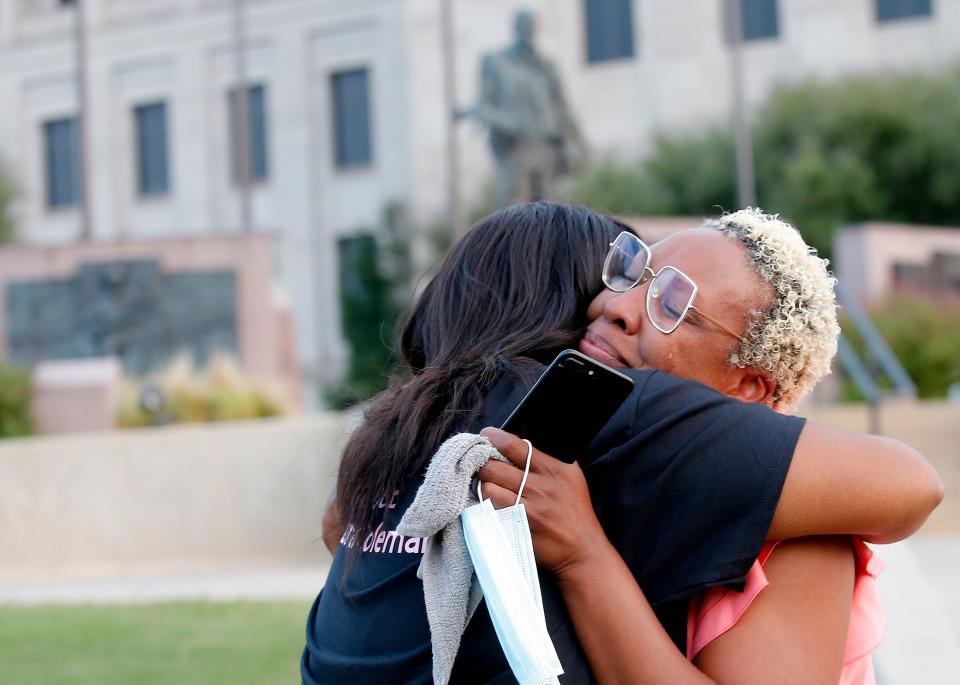 Tami Mukes hugs cousin Kendra Coleman, right, during a prayer rally outside the Oklahoma Judicial Center in 2020.