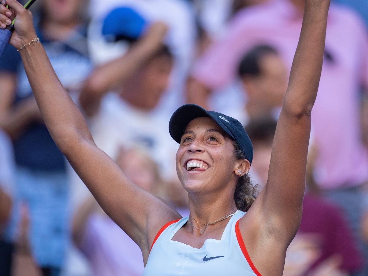 US Open competitor from the US Madison Keys holds arms up to celebrate a victory