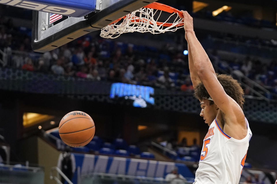 New York Knicks' Jerico Sims dunks against the Orlando Magic during the first half of an NBA basketball game, Friday, Oct. 22, 2021, in Orlando, Fla. (AP Photo/John Raoux)