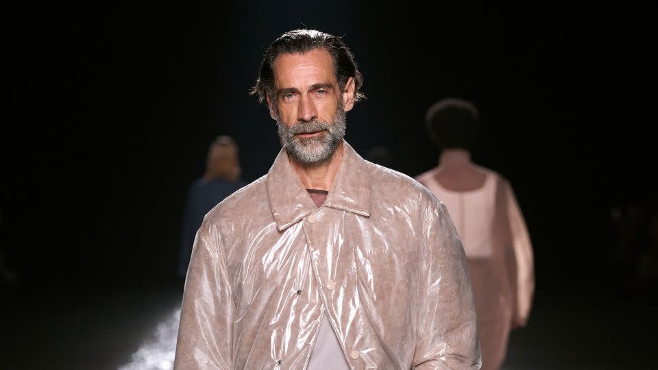 Van Noten's final show was a whirlwind of light and shimmer — from iridescent rain coats to a giant disco ball. - Daniele Oberrauch/GORUNWAY