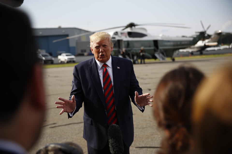 President Donald Trump speaks with reporters before boarding Air Force One at Morristown Municipal Airport in Morristown, N.J., Sunday, Aug. 18, 2019. (AP Photo/Patrick Semansky)