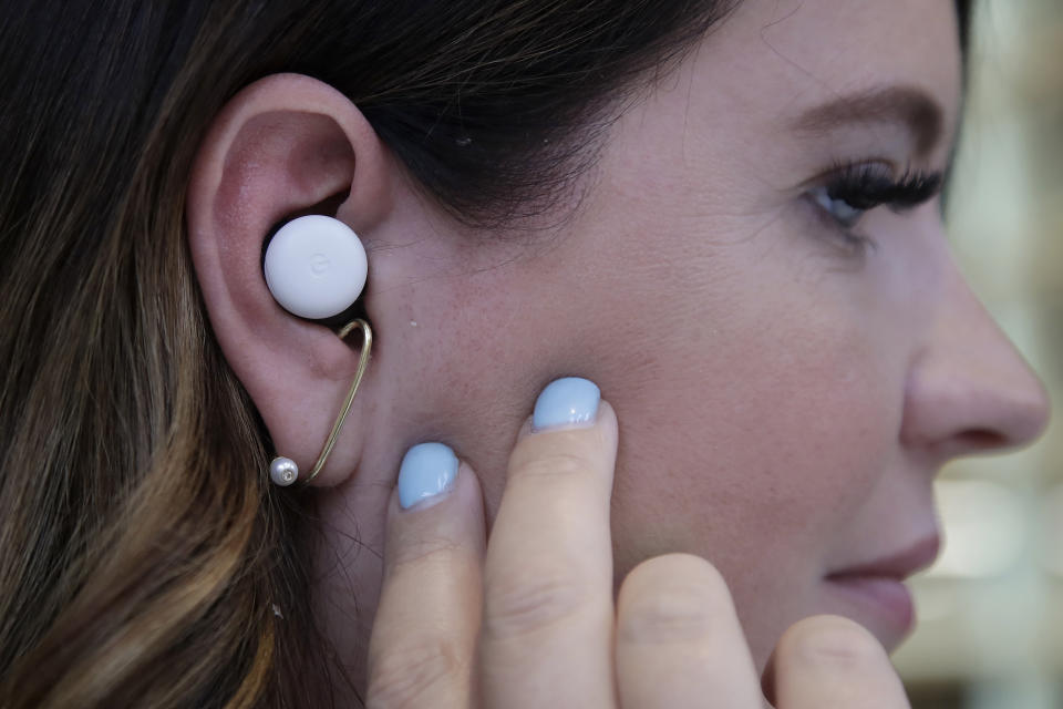 In this Tuesday, Sept. 24, 2019, photo Isabelle Olsson, head of color & design for Nest, shows Pixel buds in her ear at Google in Mountain View, Calif. (AP Photo/Jeff Chiu)