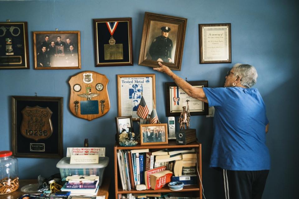 Marge Dwyer with the many plaques and awards of her hero-NYPD cop son, Anthony. Stephen Yang