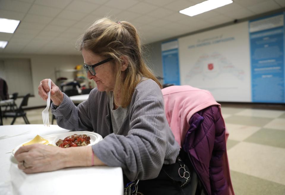 Julie Phillips takes in a meal Wednesday, February 15, 2023, at the Salvation Army warming shelter located at 237 N. Macy Street in Fond du Lac, Wis.