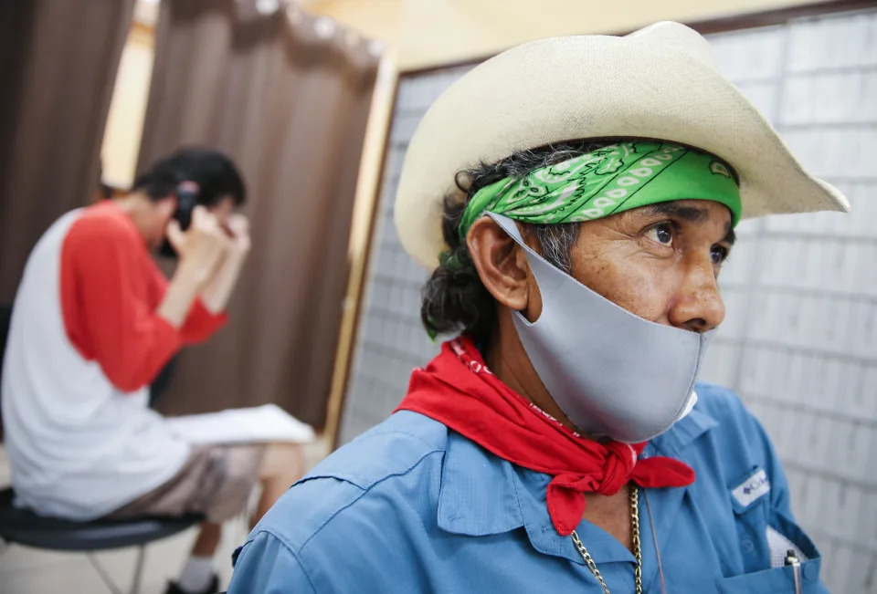 Faustino, who is currently unemployed, waits after filling out unemployment forms in a bookkeeping shop on July 24, 2020 in Calexico, California. (Photo by Mario Tama/Getty Images)