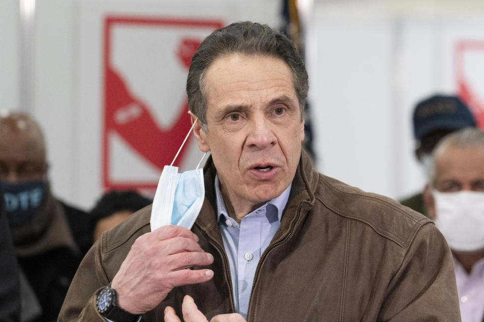 New York Gov. Andrew Cuomo removes his mask during a visit to a COVID-19 vaccination site, Monday, March 15, 2021, at the State University of New York in Old Westbury. The site is scheduled to open on Friday. (AP Photo/Mark Lennihan, Pool)