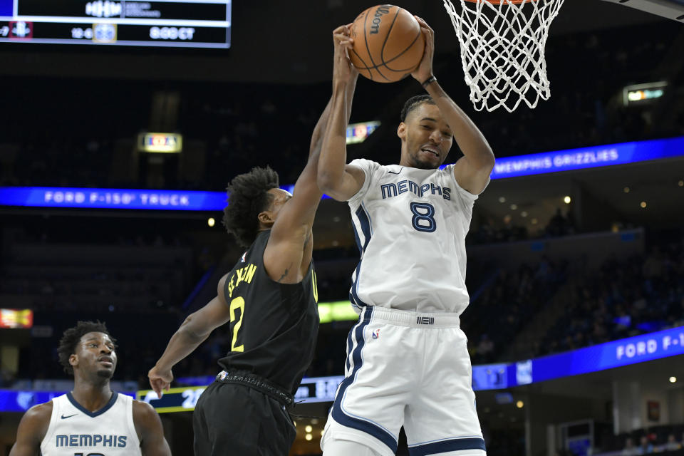 Memphis Grizzlies forward Ziaire Williams (8) grabs a rebound ahead of Utah Jazz guard Collin Sexton (2) in the first half of an NBA basketball game Wednesday, Nov. 29, 2023, in Memphis, Tenn. (AP Photo/Brandon Dill)