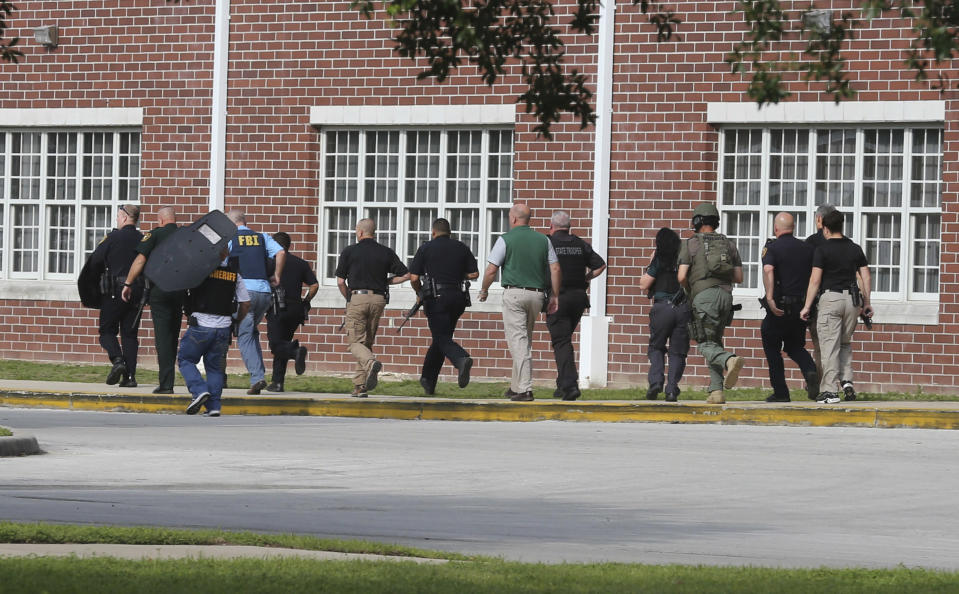 <p>Students are led out of Forest High School as law enforcement agents prepare to enter the school on Friday, April 20, 2018 in Ocala, Fla. (Photo: Bruce Ackerman/Star-Banner via AP) </p>