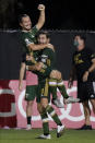 Portland Timbers midfielder Sebastian Blanco, top, celebrates his goal with Diego Valeri against the Philadelphia Union during the second half of an MLS soccer match, Wednesday, Aug. 5, 2020, in Kissimmee, Fla. (AP Photo/John Raoux)