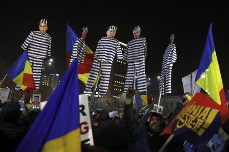 Protesters hold effigies with the faces of leader of Romania's leftist Social Democrat Party (PSD) Liviu Dragnea (R) and other members of the party dressed as prisoners, during a demonstration in Bucharest, Romania, February 3, 2017. REUTERS/Stoyan Nenov