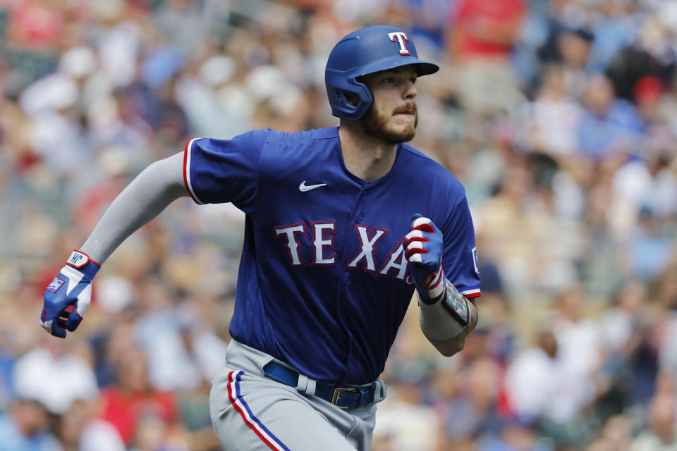 Texas Rangers' Jonah Heim runs the bases as he watches his grand slam against the Minnesota Twins in the fourth inning of a baseball game Sunday, Aug. 27, 2023, in Minneapolis. (AP Photo/Bruce Kluckhohn)