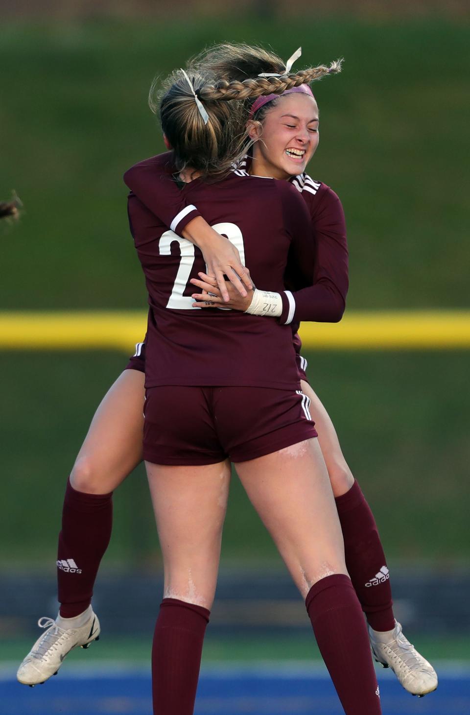 Walsh Jesuit's Sara Costantini, facing, celebrates with Kayla Flory after her goal during the first half of a Division I district championship soccer game against Green at NDCL, Thursday, Oct. 27, 2022, in Chardon, Ohio.