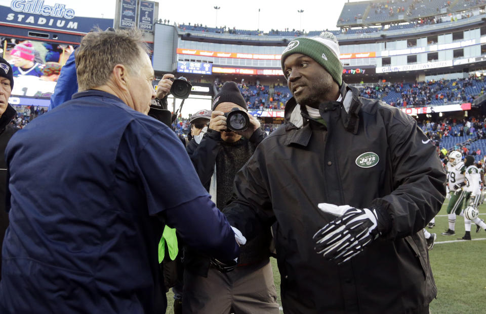 New England Patriots head coach Bill Belichick, left, and New York Jets head coach Todd Bowles speak at midfield after an NFL football game, Saturday, Dec. 24, 2016, in Foxborough, Mass. The Patriots won 41-3. (AP Photo/Elise Amendola)