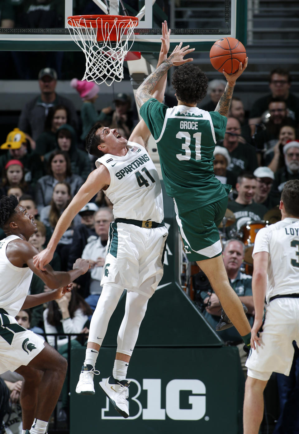Eastern Michigan's Ty Groce (31) goes up against the defense of Michigan State's Conner George (41) during the second half of an NCAA college basketball game, Saturday, Dec. 21, 2019, in East Lansing, Mich. (AP Photo/Al Goldis)