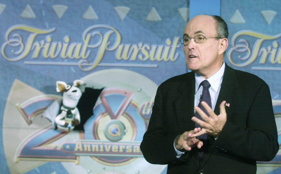 NEW YORK - SEPTEMBER 21:  Former New York Mayor Rudy Giuliani speaks to the Pets.Com sock puppet during an event celebrating the release of the 20th anniversary edition of the board game Trivial Pursuit September 24, 2002 at the Toys 'R' Us flagship store in New York City.  (Photo by Keith Bedford/Getty Images) 