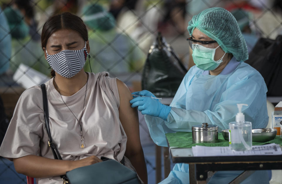 A health worker administers a dose of the Sinovac COVID-19 vaccine to a worker in a local entertainment venue area where a new cluster of COVID-19 infections were found in Bangkok, Thailand, Wednesday, April 7, 2021. Officials in Thailand’s capital have ordered a two-week closure of all entertainment venues in three districts to try to limit the spread of the coronavirus from nightspots there. (AP Photo/Sakchai Lalit)