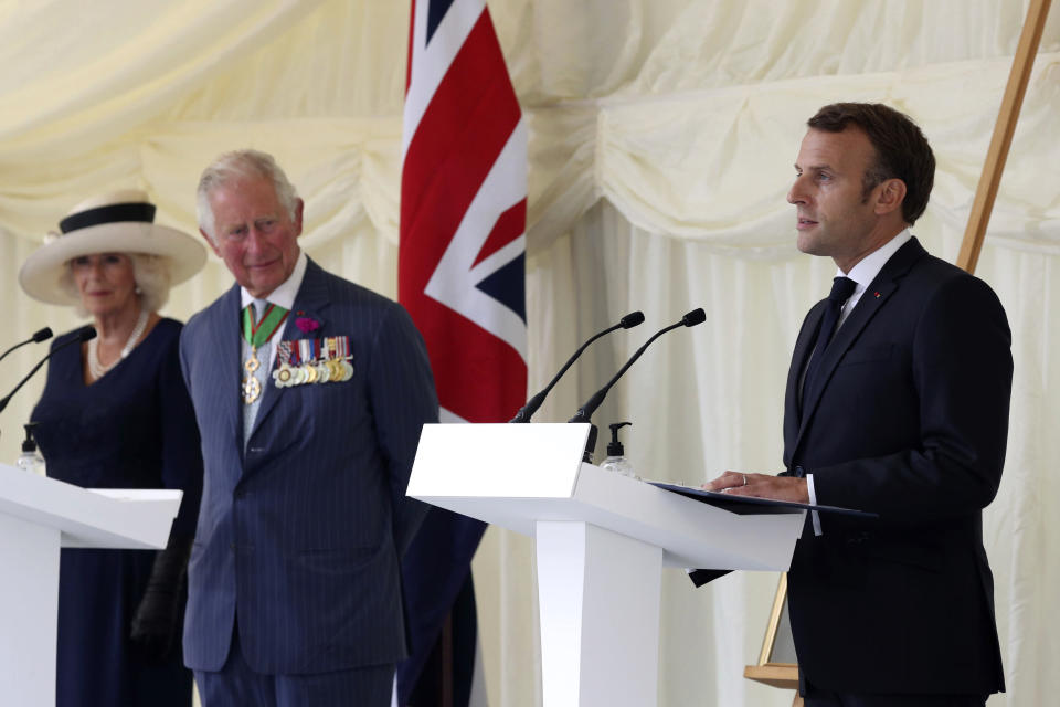 FILE - Britain's Prince Charles and Camilla, Duchess of Cornwall look on as French President Emmanuel Macron, right, makes a speech following laying a wreath at a ceremony at Carlton Gardens in London, Thursday June 18, 2020. French President Emmanuel Macron’s office on Friday, March 24, 2023, said a state visit by Britain’s King Charles III has been postponed amid mass strikes and protests in France. The king had been scheduled to arrive in France on Sunday on his first state visit as monarch, before heading to Germany on Wednesday. (Jonathan Brady/Pool via AP, File)