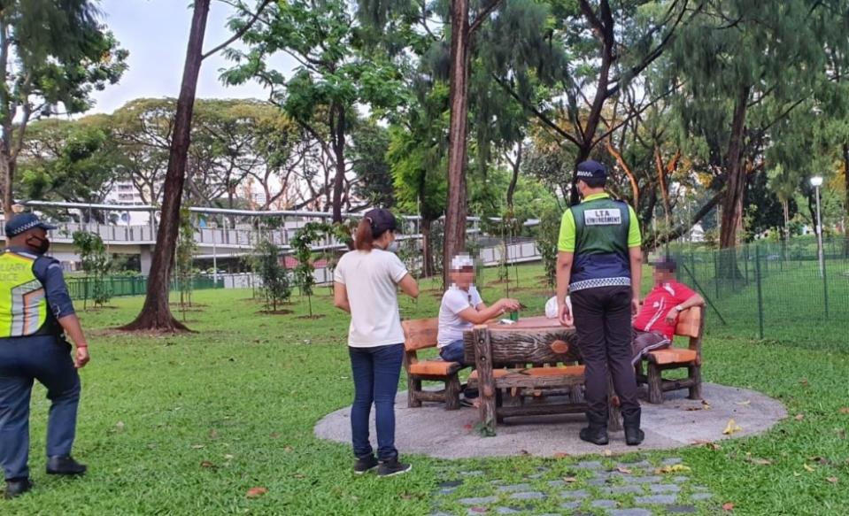 Enforcement officers speaking to members of the public at Bishan-Ang Mo Kio Park. (PHOTO: Masagos Zulkifli/Facebook)