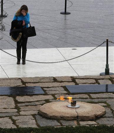 A woman pays her respects at Arlington National Cemetery to mark the 50th anniversary of the assassination of U.S. President John F. Kennedy at his gravesite in Arlington November 22, 2013. REUTERS/Larry Downing