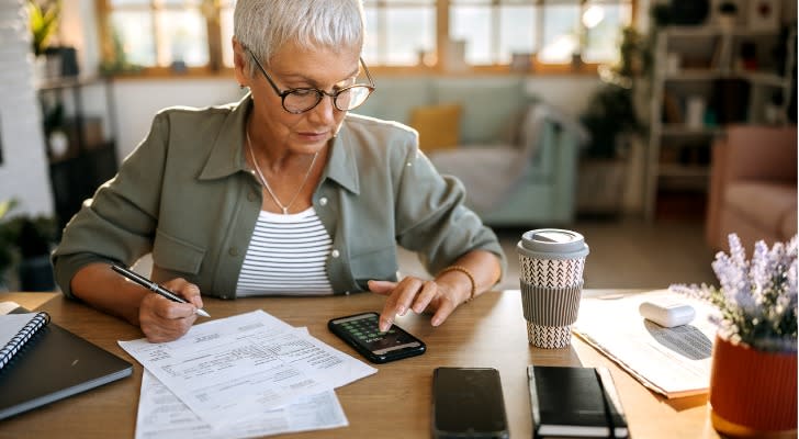 A woman calculating her Roth IRA conversion ladder