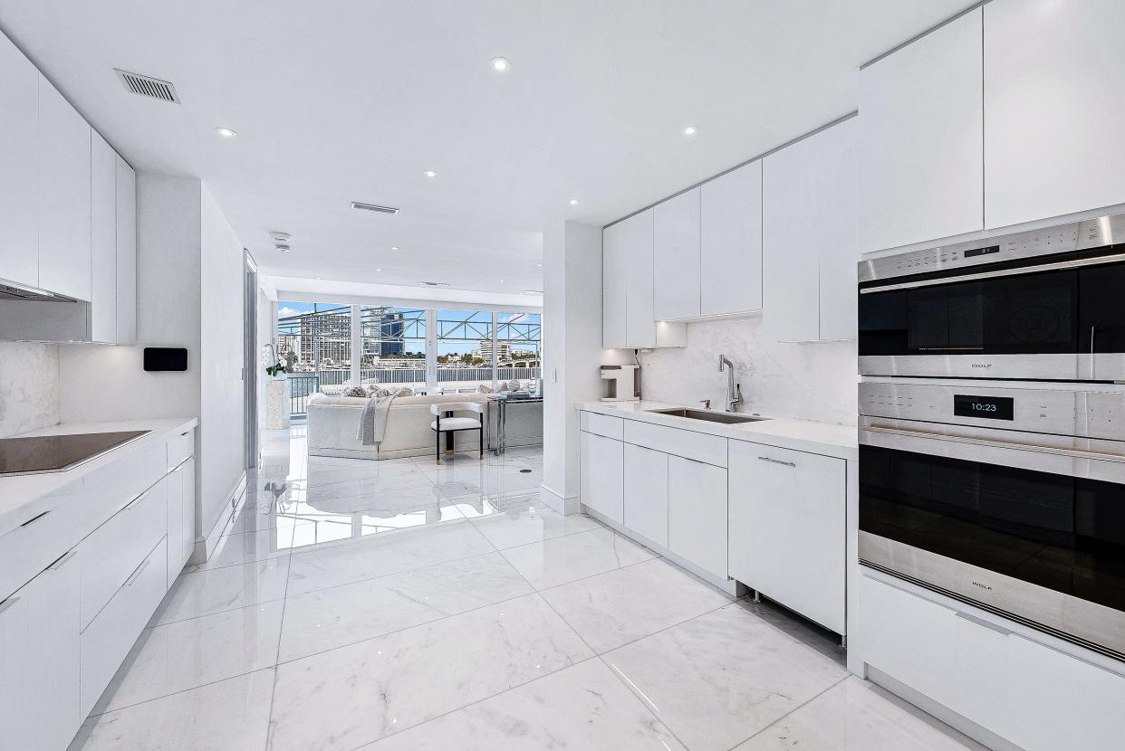 The sleek galley-style kitchen has a view, thanks to its position off the living room.