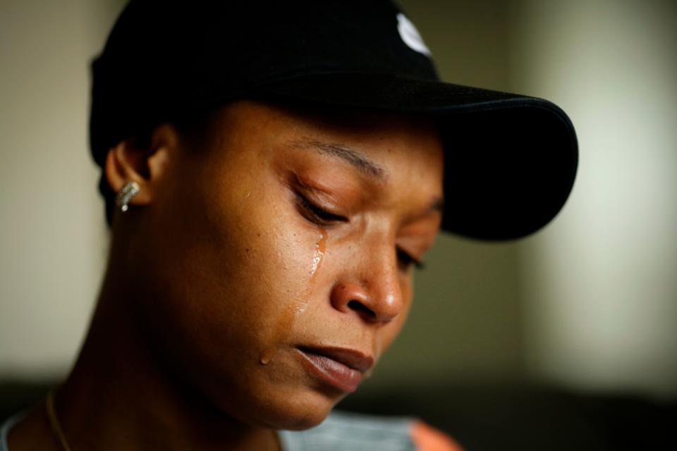 Whitney Burns, 29, of Northside, remembers her sister as tears run down her cheeks at her home in the Northside neighborhood of Cincinnati on Monday, May 20, 2019. Burns' sister, Chae'von Bowman, died at the age of 31 when her house caught fire on April 29. Just that morning she had picked up her high school diploma after returning to school to finish her education as an adult.