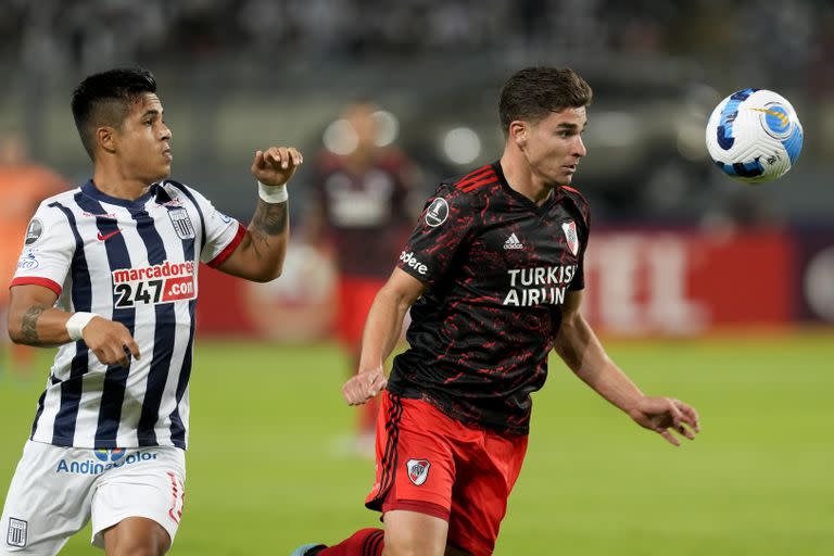 Julian Alvarez of Argentina's River Plate, right, and Ricardo Lagos of Peru's Alianza Lima battle for the ball during a Copa Libertadores soccer match in Lima, Peru, Wednesday, April 6, 2022. (AP Photo/Martin Mejia)