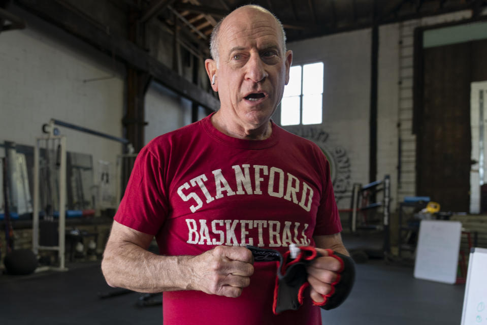 FILE - Ohio Congressional candidate Phil Heimlich prepares to work out at Cincinnati Fitness & Boxing in Cincinnati , Saturday, April 23, 2022. Heimlech is one of 11 candidates vying for the Republican nomination for a seat in Ohio’s 2nd Congressional District, which extends from suburban Cincinnati to the West Virginia border. The winner of the primary will face Democrat Samantha Meadows in the November general election. (AP Photo/Jeff Dean, File)