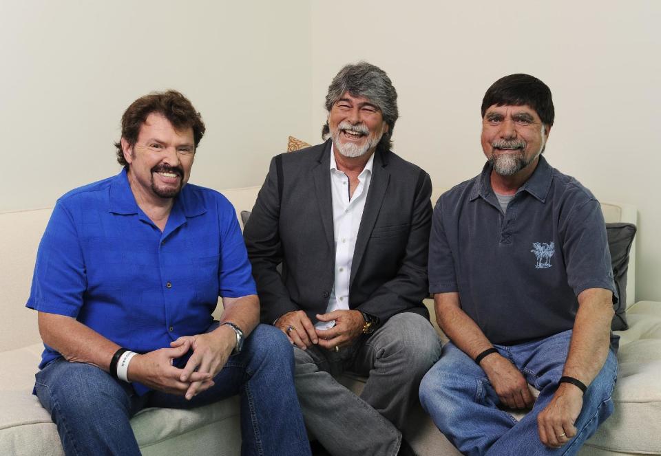 In this Tuesday, Aug. 13, 2013 photo, Jeff Cook, Randy Owen and Teddy Gentry from the American country music band Alabama pose for a portrait in Nashville, Tenn. Alabama has launched a tour and released a new album this week, “Alabama & Friends,” that features duets of the group’s biggest hits with top country stars. (Photo by Donn Jones/Invision/AP)