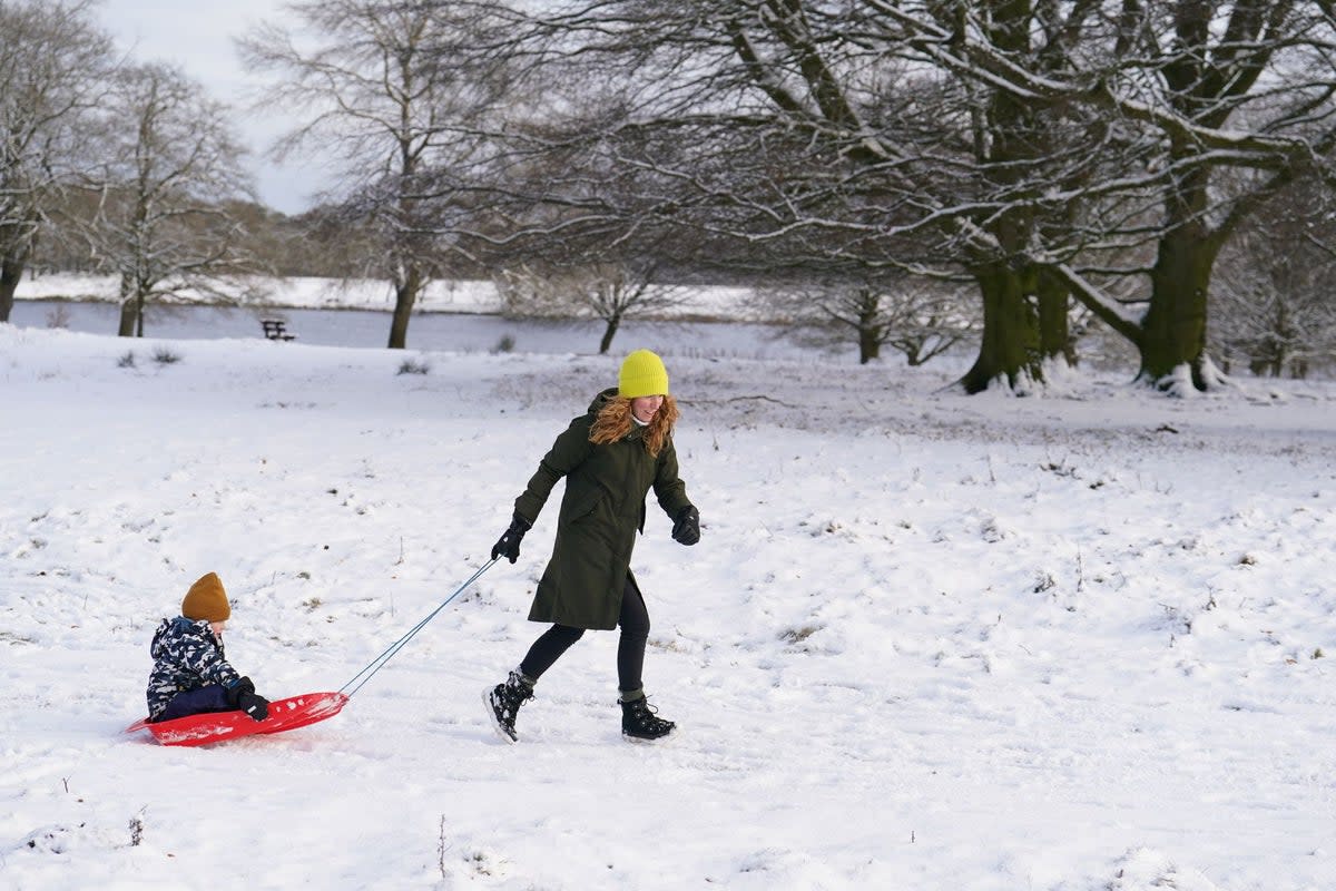 Liz and son Henry sledging on the snow in Tatton Park, Knutsford, Cheshire, on Tuesday (Martin Rickett/PA Wire)