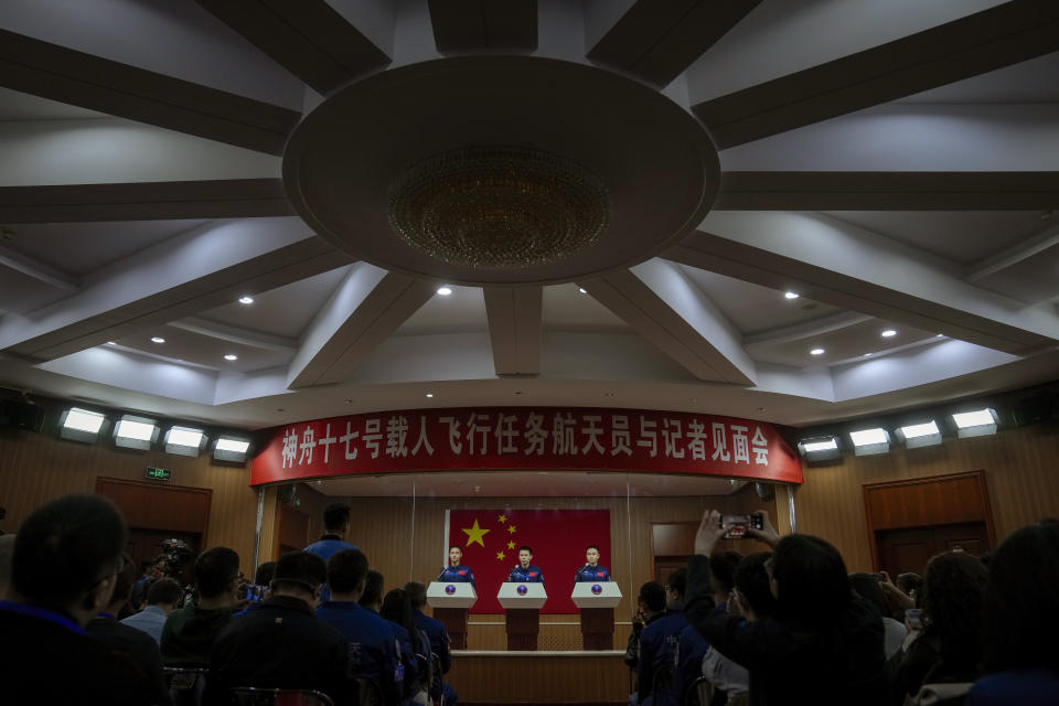 Chinese astronauts for the upcoming Shenzhou-17 mission, from left, Jiang Xinlin, Tang Hongbo and Tang Shengjie take a question from a reporter during a meeting with the press at the Jiuquan Satellite Launch Center in northwest China, Wednesday, Oct. 25, 2023. (AP Photo/Andy Wong)