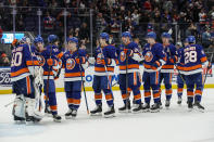 New York Islanders celebrate after defeating the Chicago Blackhawks in an NHL hockey game on Sunday, Dec. 4, 2022, in Elmont, N.Y. Islanders won 3-0. (AP Photo/Eduardo Munoz Alvarez)