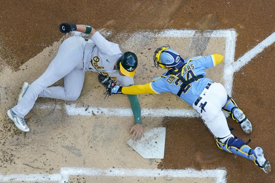 Oakland Athletics' Ryan Noda slides home safely under the tag of Milwaukee Brewers catcher William Contreras during the first inning of a baseball game Friday, June 9, 2023, in Milwaukee. (AP Photo/Morry Gash)