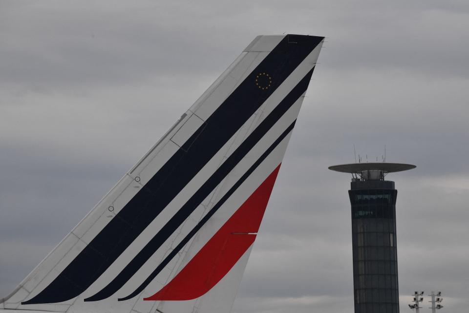 Tail of an Air France airplane and an air traffic control tower at the Roissy-Charles de Gaulle airport amid a strike of air traffic controllers. Photo: Julien De Rosa/AFP via Getty Images