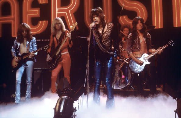 brad whitford, tom hamilton, steven tyler, joey kramer, and joe perry perform on stage